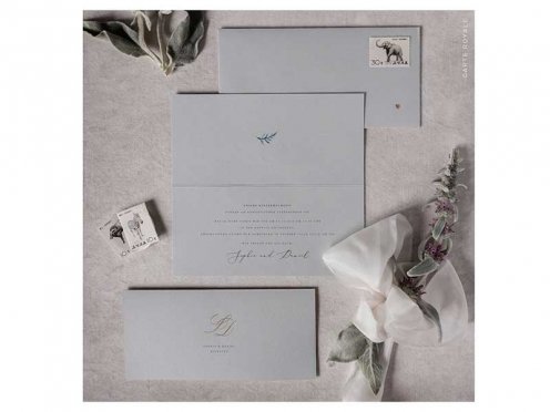 Einladungskarten mit geprägten Initialen auf hochwertigem Papier in edlem Grau. Briefumschlag mit goldenem Herz.
